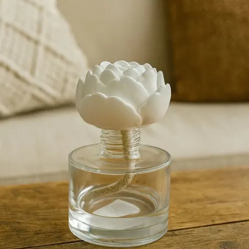 Difusor de vidrio con una flor de yeso como tapa